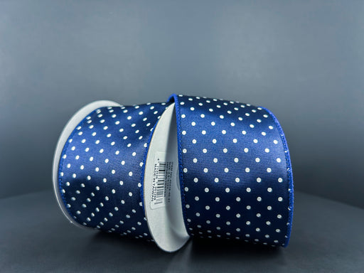 The 2.5X10Y Navy White Ribbed Satin Microdots Ribbon, labeled 42419-40-27, features two angled rolls with evenly distributed white polka dots on a navy background, placed against gray. One roll displays a barcode label.